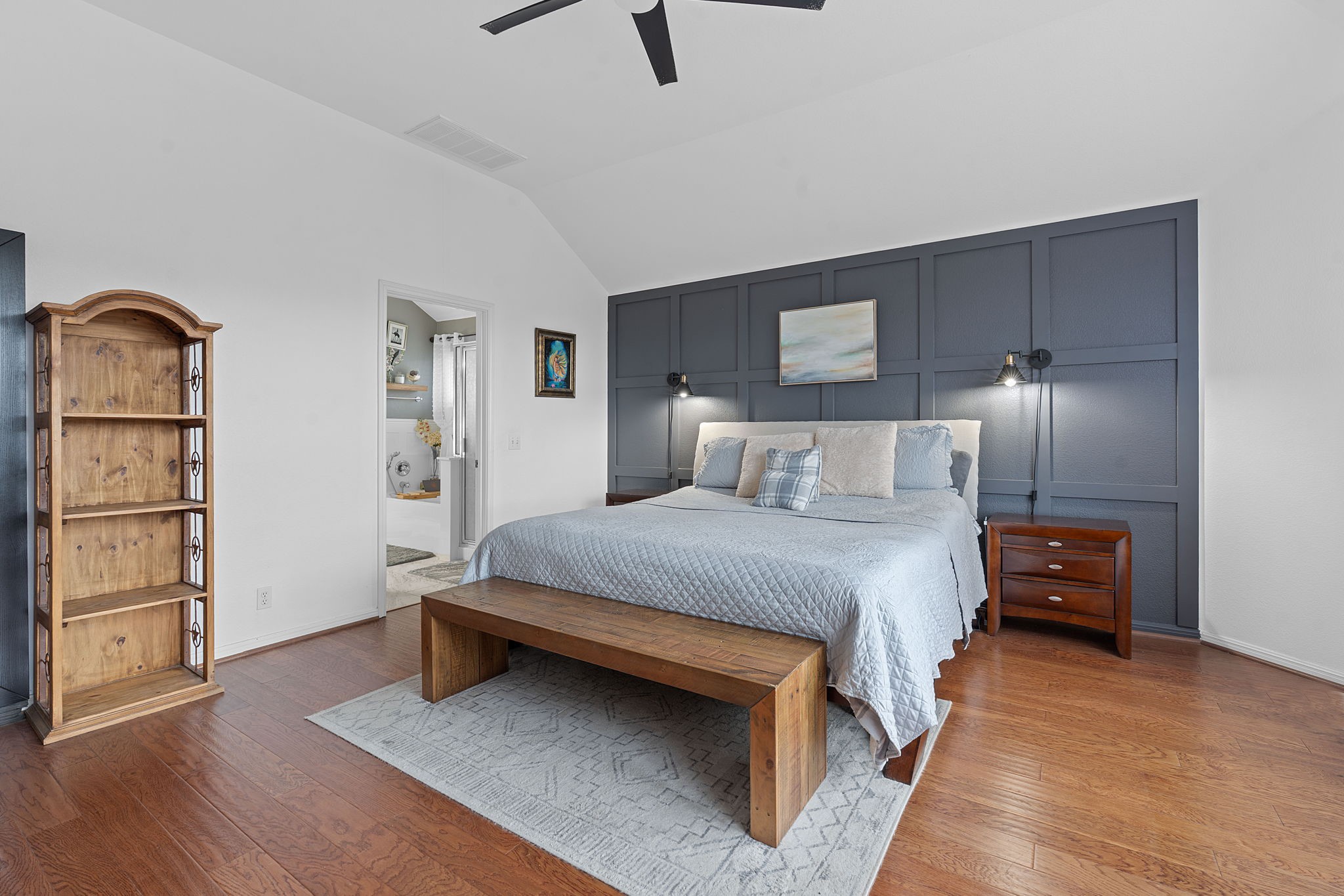 150 Manchester Lane Austin, TX 78737 - Photo 12 of 24 a bedroom with a bed and wooden floor