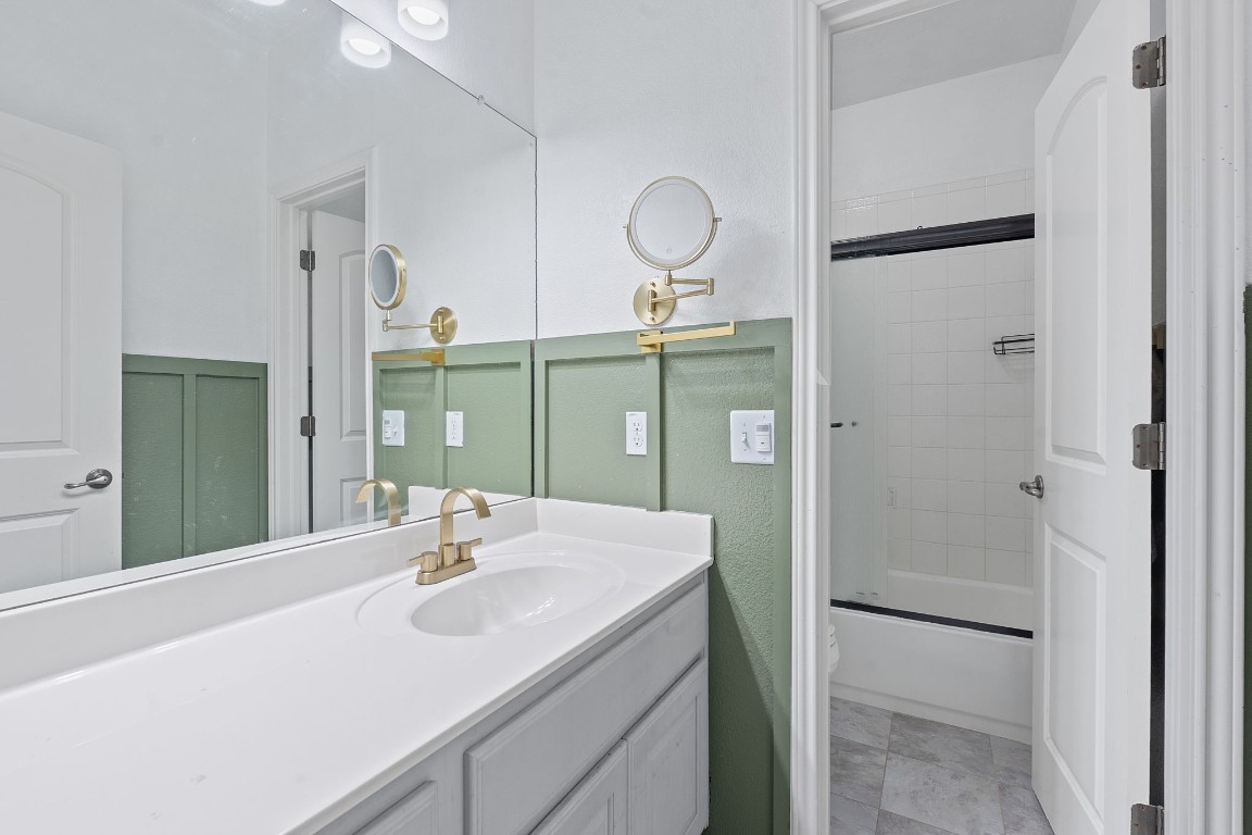 150 Manchester Lane Austin, TX 78737 - Photo 18 of 24 Full bathroom with vanity and bath / shower combo with glass door