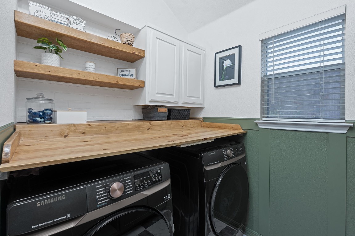 150 Manchester Lane Austin, TX 78737 - Photo 20 of 24 Washroom featuring wainscoting, cabinet space, and washing machine and clothes dryer