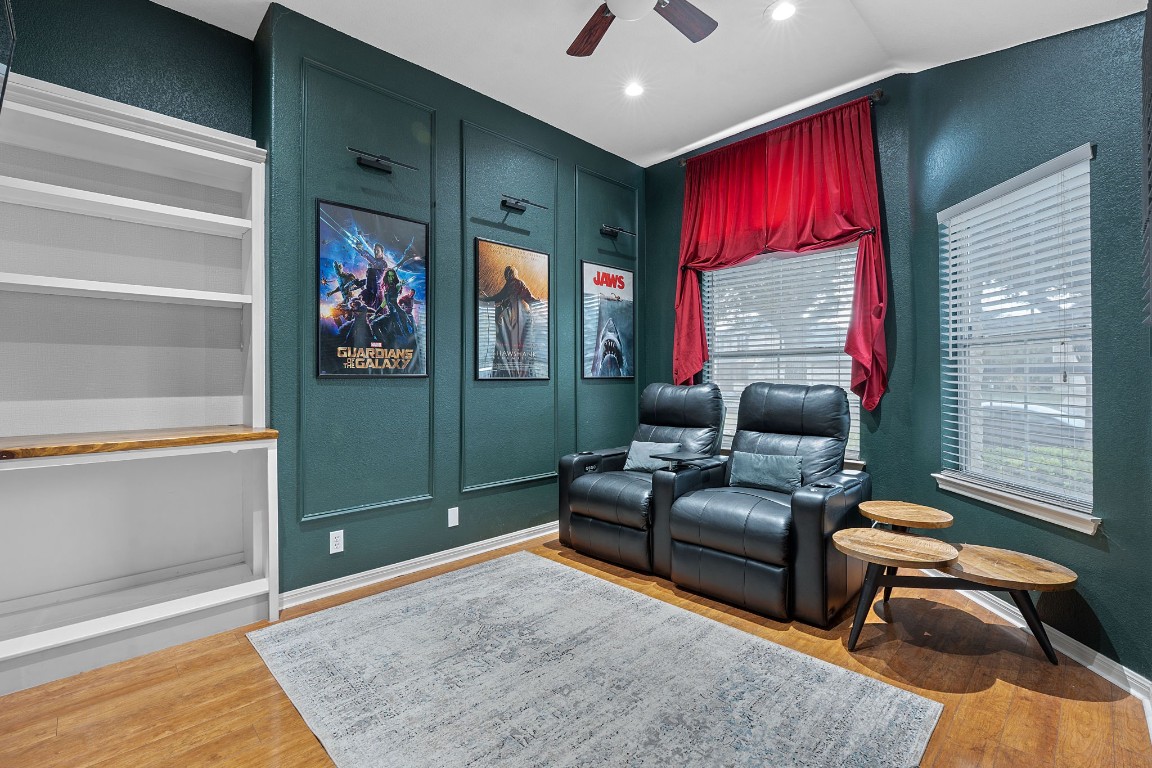 150 Manchester Lane Austin, TX 78737 - Photo 21 of 24 Cinema featuring a textured wall, wood finished floors, and a ceiling fan