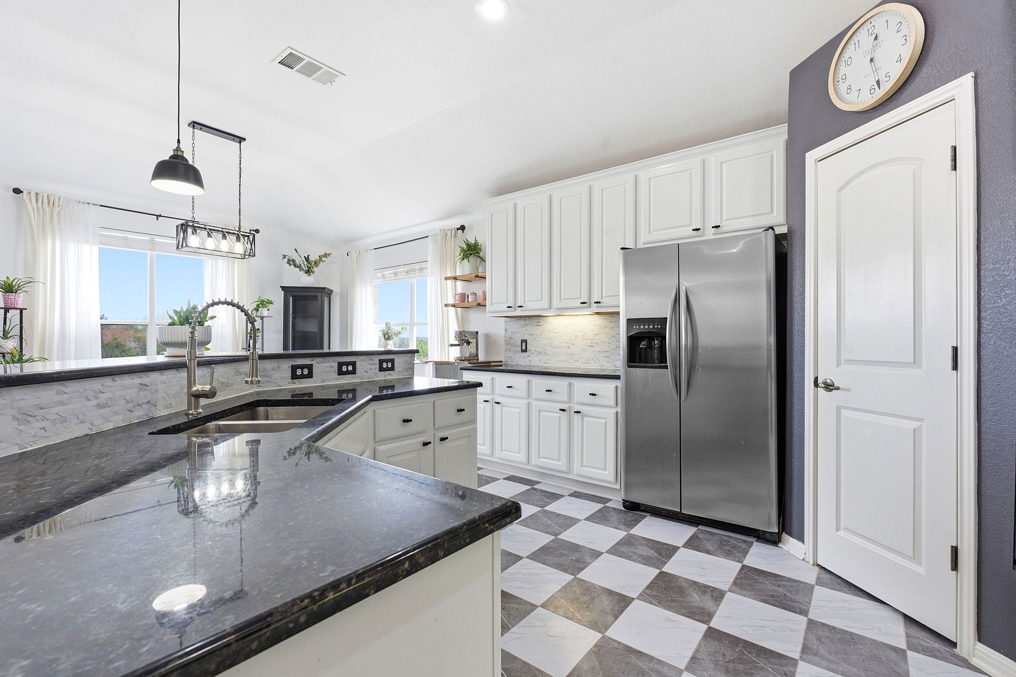 150 Manchester Lane Austin, TX 78737 - Photo 9 of 24 a kitchen with stainless steel appliances granite countertop a sink a refrigerator and a stove with white countertops