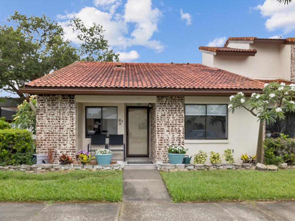 7360 Ulmerton Road, Unit 18A Largo, FL 33771 - Photo 1 of 1 a front view of a house with a garden and plants