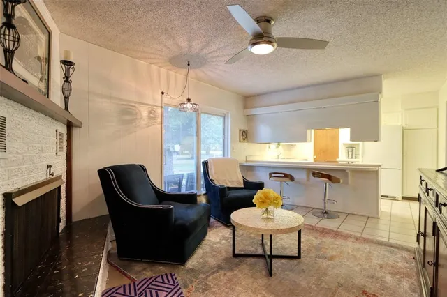a living room with furniture a window and kitchen view