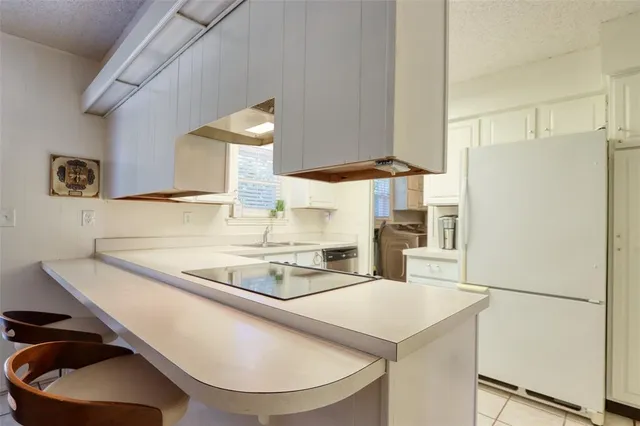 a kitchen with stainless steel appliances granite countertop a sink a stove and a refrigerator