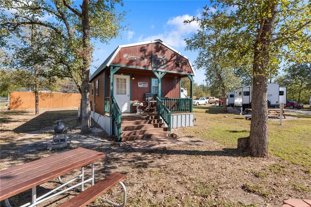 a living room with fireplace furniture and a flat screen tv