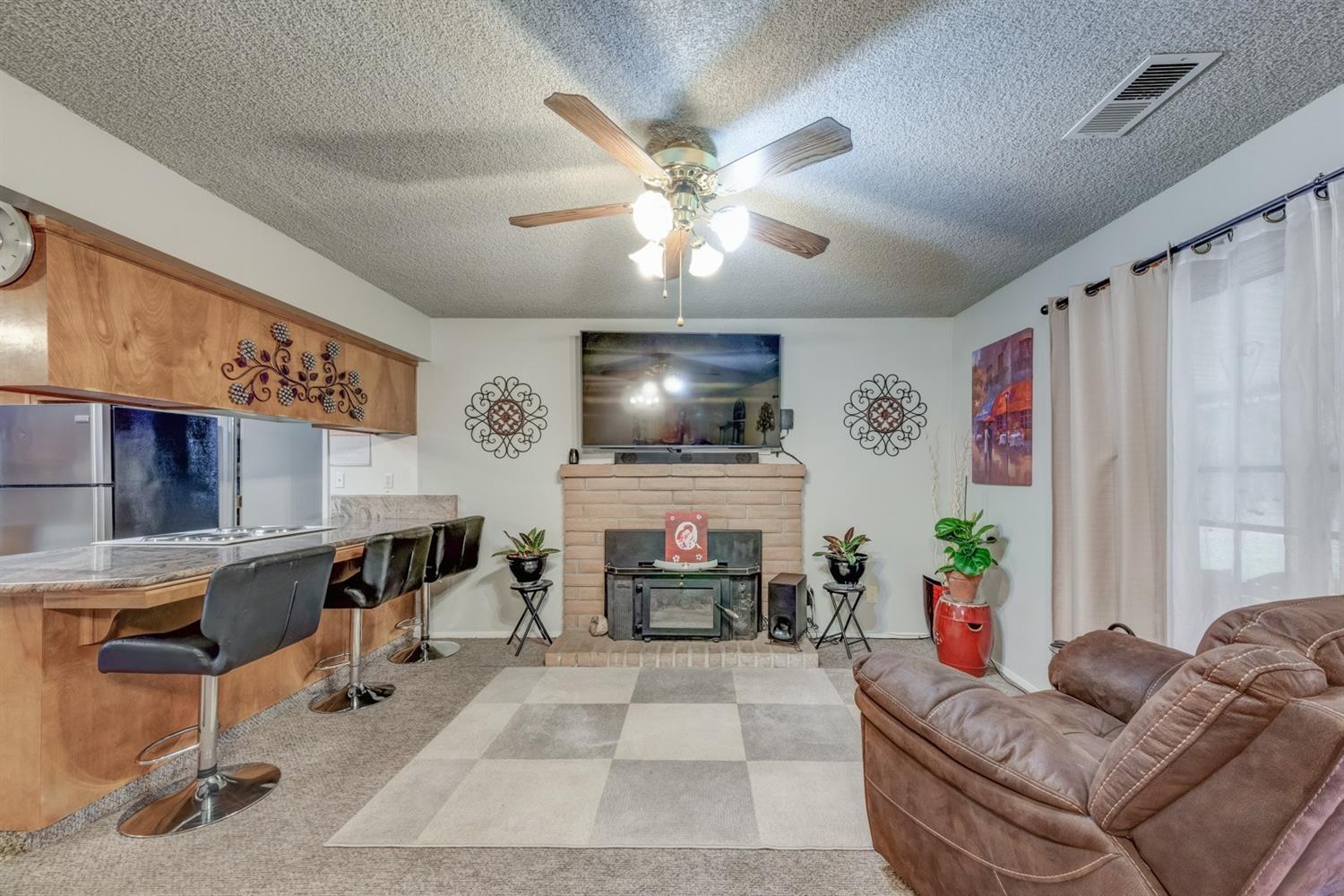 17609 Rodeo Drive Madera, CA 93638 - Photo 11 of 31 Open layout, breakfast bar,fireplace and so much more.
