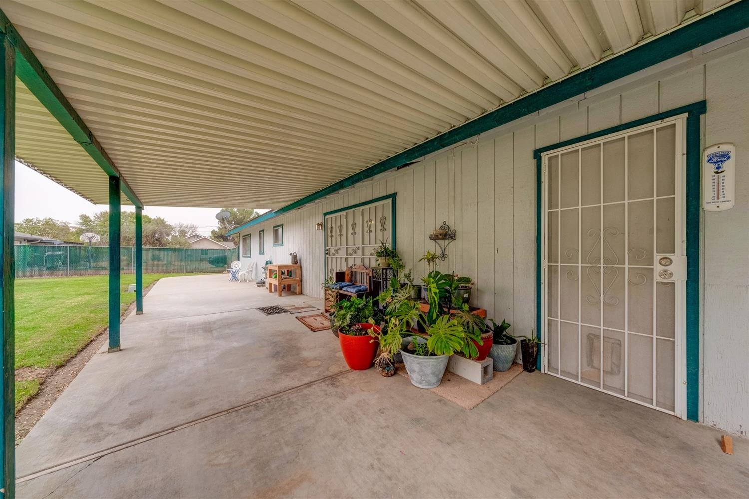 17609 Rodeo Drive Madera, CA 93638 - Photo 27 of 31 Covered patio area overseeing your .51 acres, enjoy an evening entertaining your family in your own yard, no lack of space.
