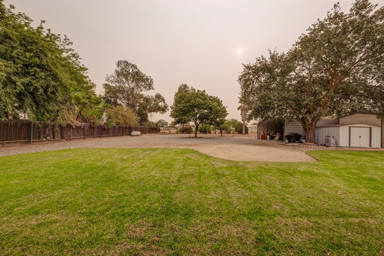 17609 Rodeo Drive Madera, CA 93638 - Photo 29 of 31 Two sheds, one open and one completely inclosed, mature landscape, .51 acres.