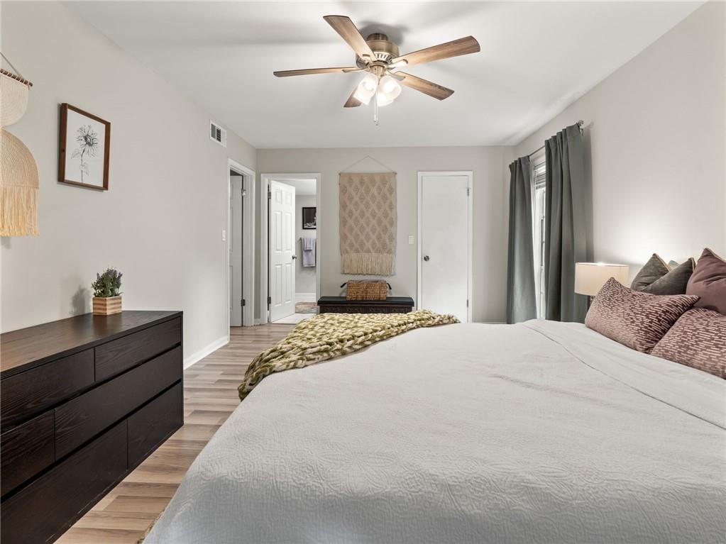 6851 Roswell Road, Unit H26 Atlanta, GA 30328 - Photo 16 of 49 a bedroom with a large bed and a chandelier