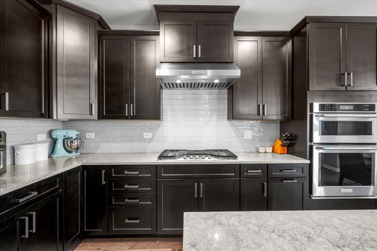 1261 Falcon Ridge Drive Elgin, IL 60124 - Photo 11 of 25 a kitchen with stainless steel appliances granite countertop a stove a sink and a refrigerator
