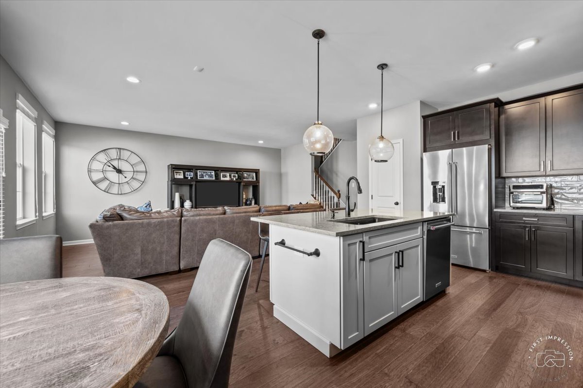 1261 Falcon Ridge Drive Elgin, IL 60124 - Photo 12 of 25 a kitchen with stainless steel appliances granite countertop a sink a stove and refrigerator