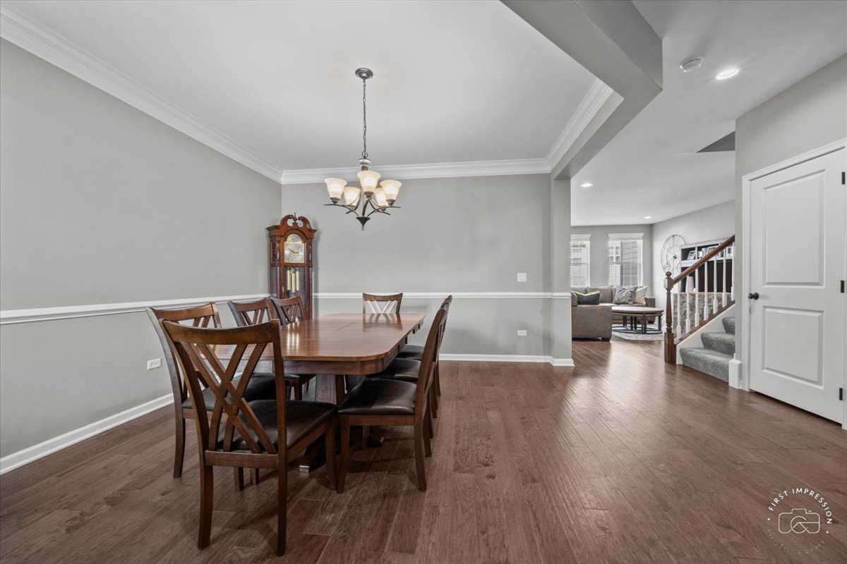 1261 Falcon Ridge Drive Elgin, IL 60124 - Photo 3 of 25 a view of a dining room with furniture wooden floor and chandelier