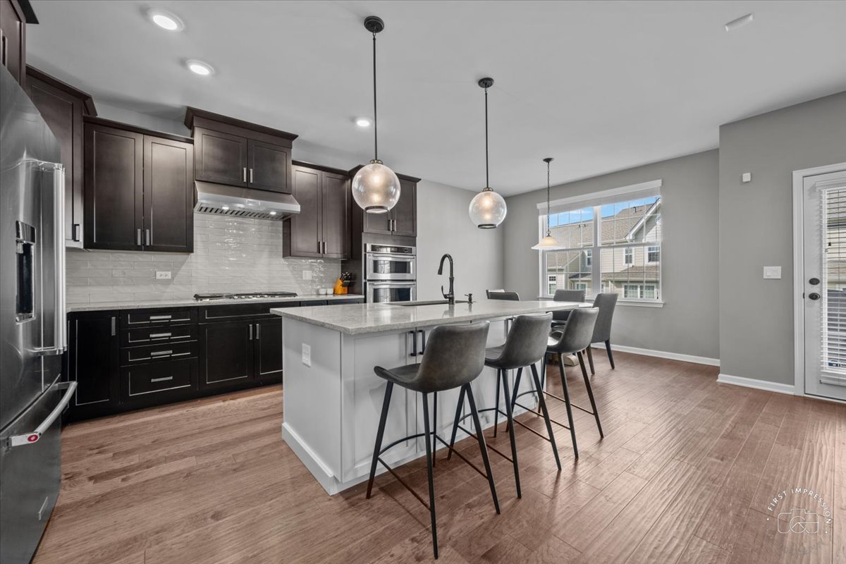 1261 Falcon Ridge Drive Elgin, IL 60124 - Photo 7 of 25 a kitchen with a table and chairs in it