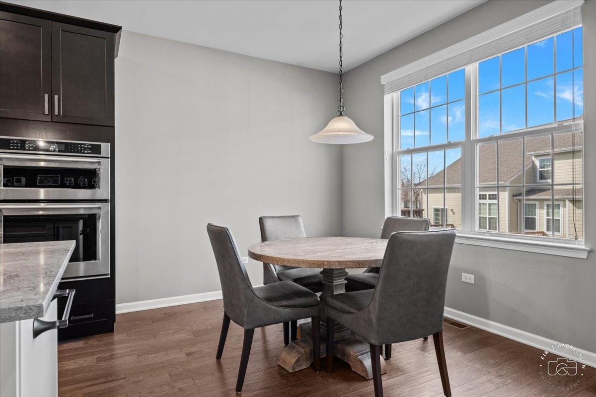 1261 Falcon Ridge Drive Elgin, IL 60124 - Photo 8 of 25 a view of a dining room with furniture window and wooden floor