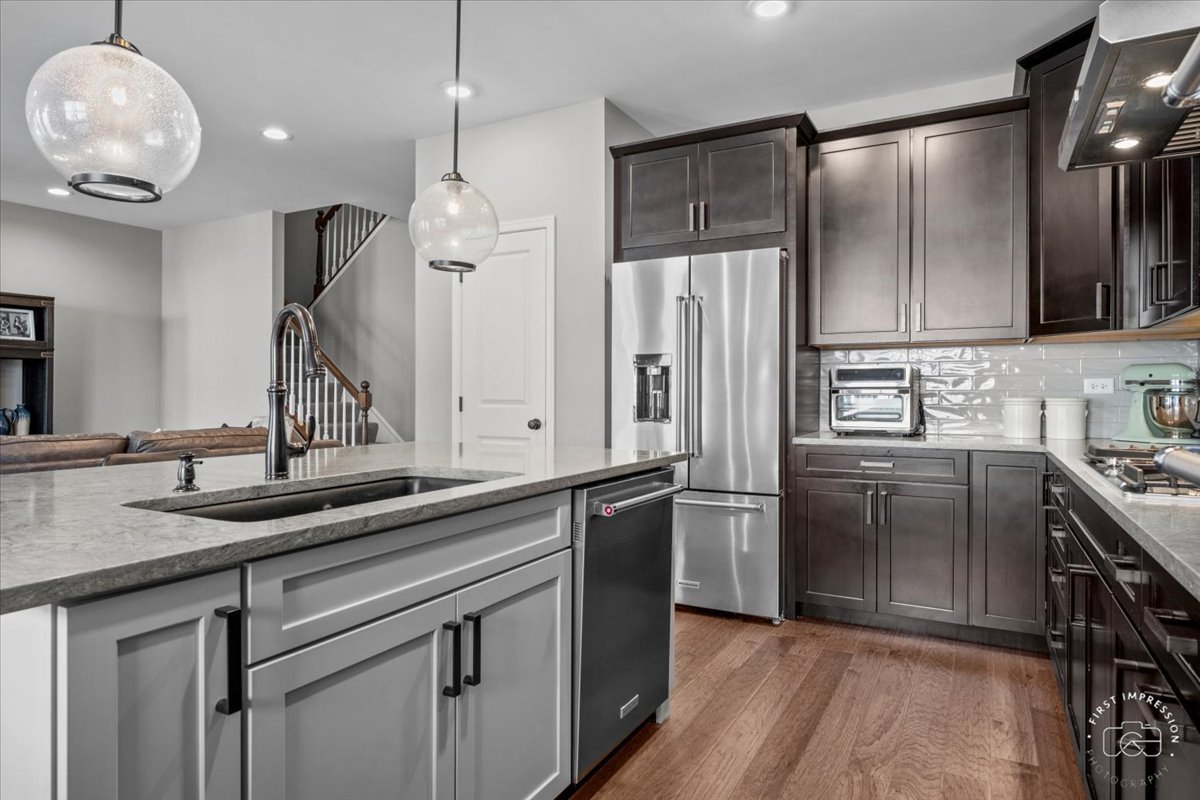1261 Falcon Ridge Drive Elgin, IL 60124 - Photo 10 of 25 a kitchen with kitchen island granite countertop a sink a counter space appliances and cabinets