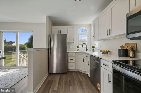 a kitchen with a refrigerator stove and sink