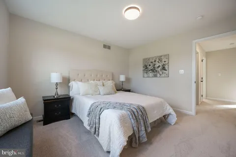 a bedroom with a bed and a lamp