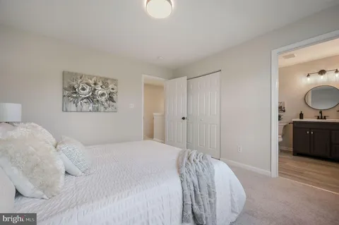 a bedroom with a bed and mirror