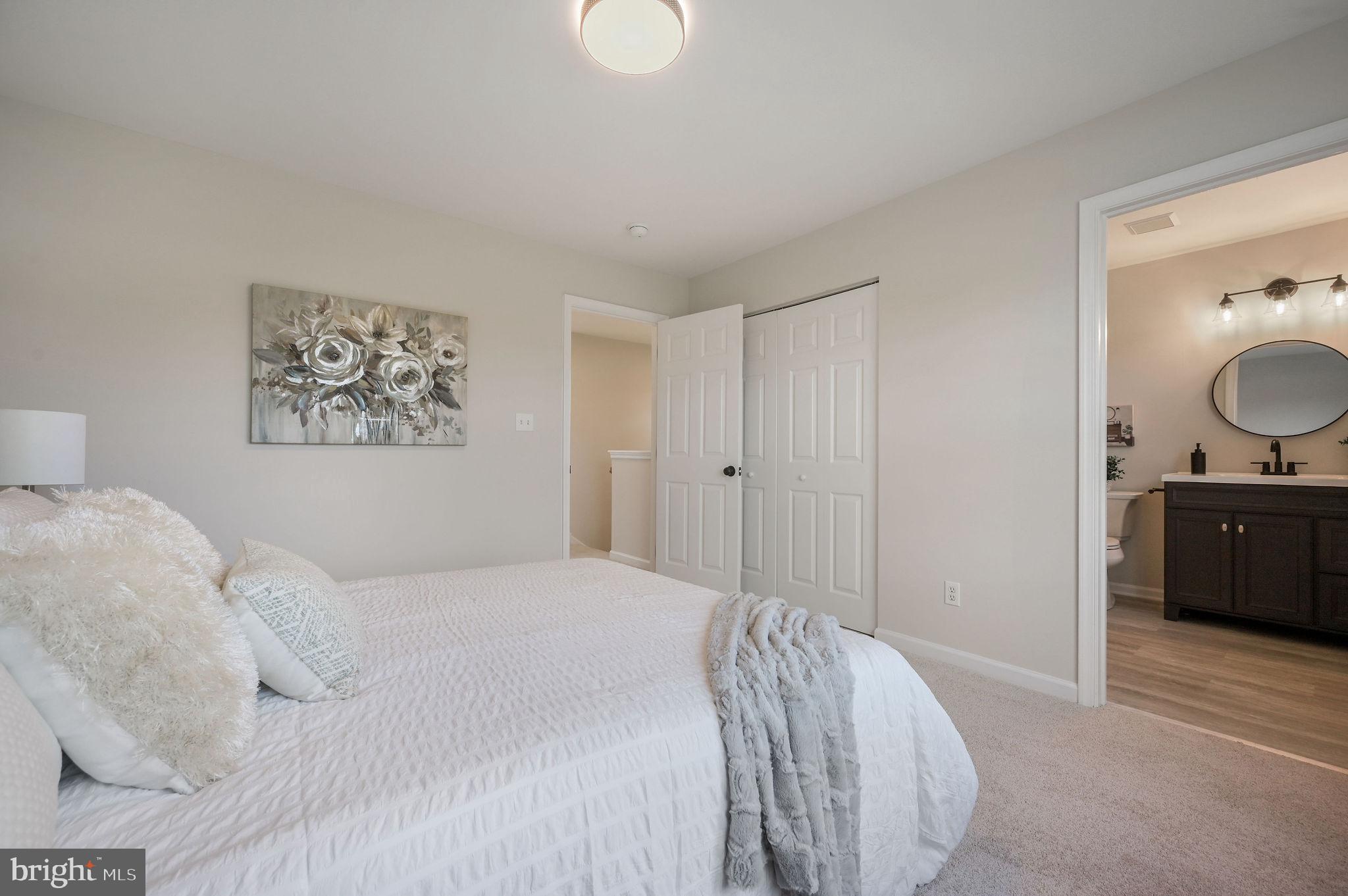 63 Raphael Road Smyrna, DE 19977 - Photo 15 of 27 a bedroom with a bed and mirror