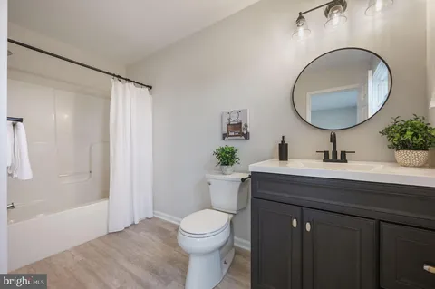a bathroom with a toilet a sink and a mirror