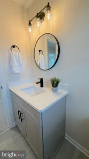 a bathroom with a sink a mirror and vanity
