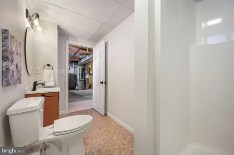 a white toilet sitting next to a bathroom sink