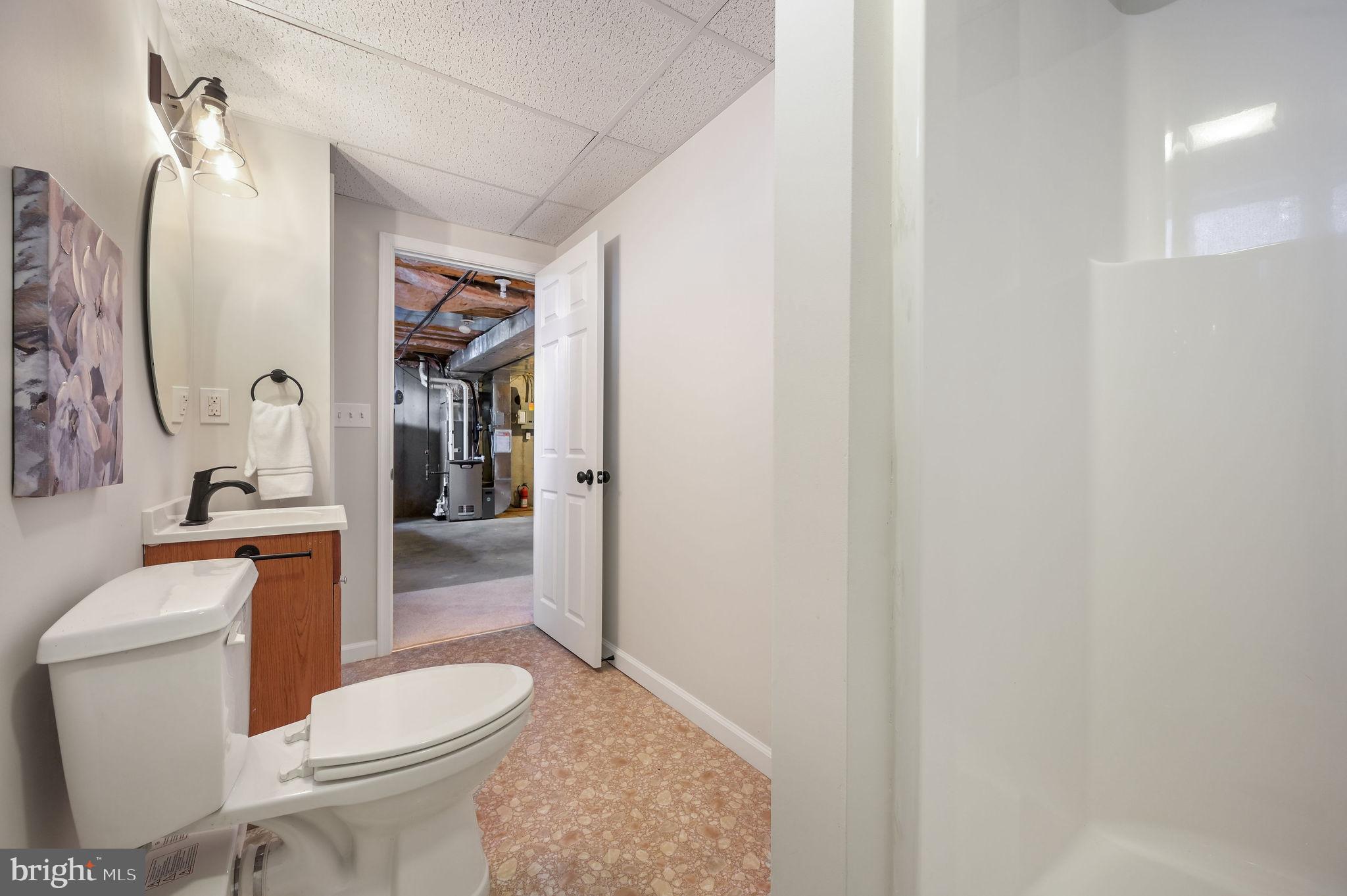 63 Raphael Road Smyrna, DE 19977 - Photo 25 of 27 a white toilet sitting next to a bathroom sink