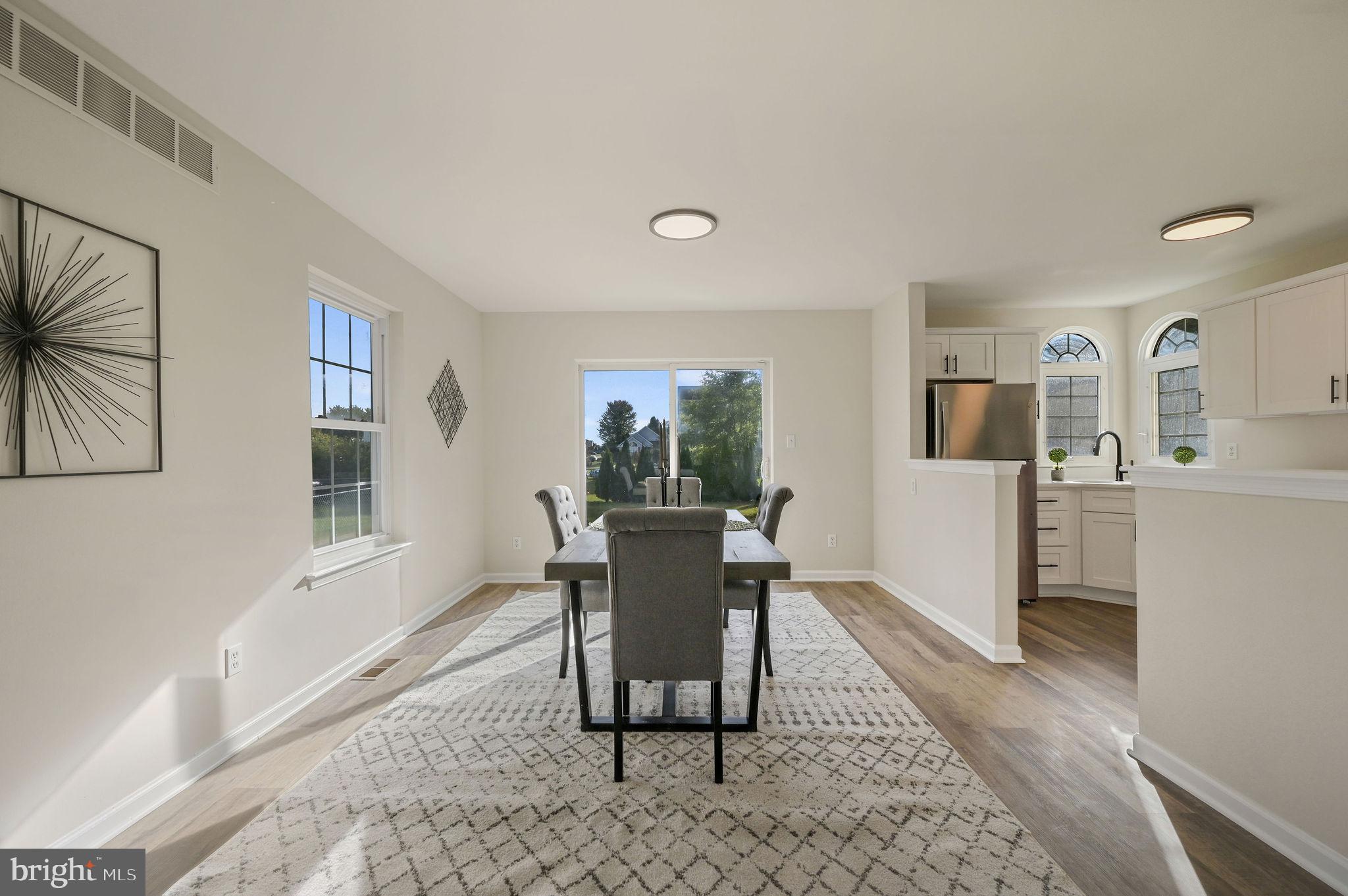 63 Raphael Road Smyrna, DE 19977 - Photo 6 of 27 a dining room with wooden floor and a rug