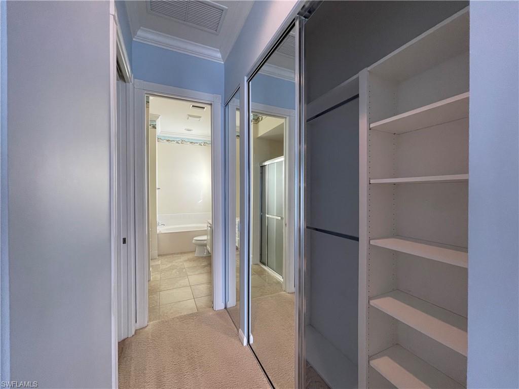 7025 Leopardi Court Naples, FL 34114 - Photo 17 of 48 a view of an empty walk in closet