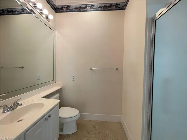 a white toilet sitting next to a bathroom sink