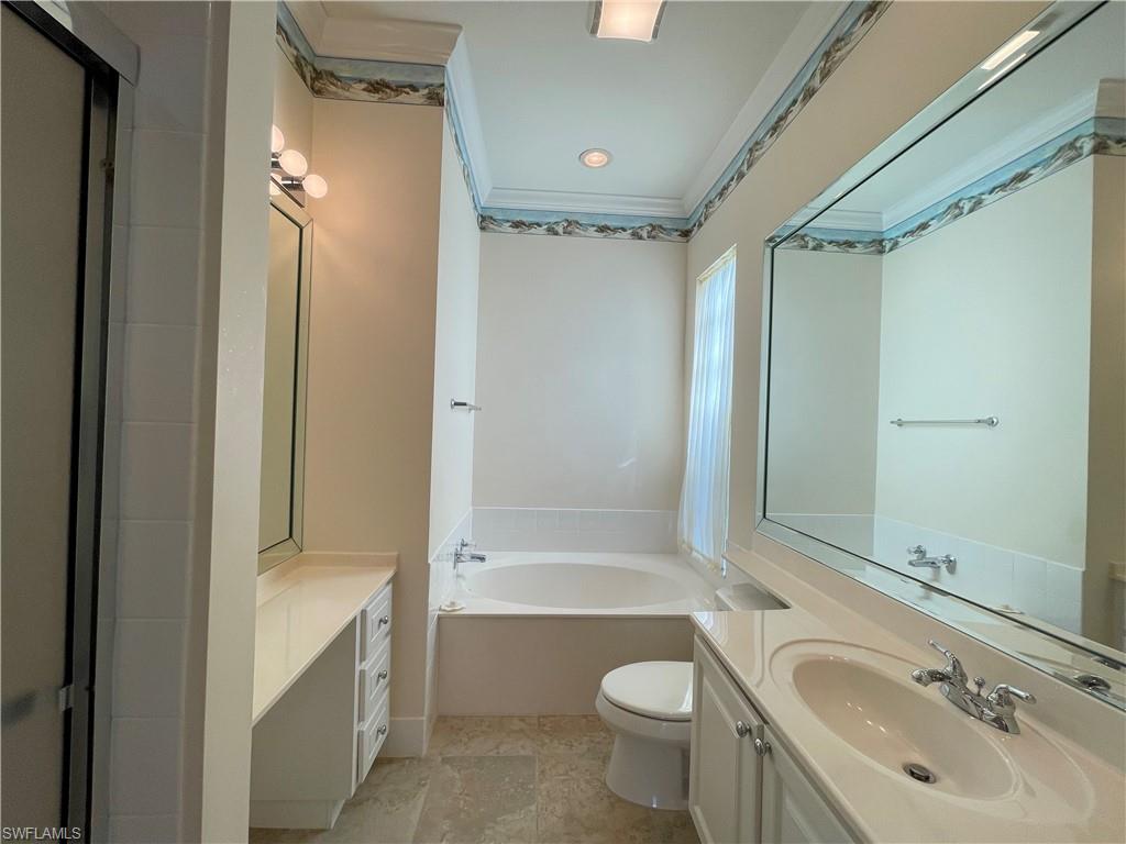 7025 Leopardi Court Naples, FL 34114 - Photo 21 of 48 a bathroom with a granite countertop sink toilet and shower