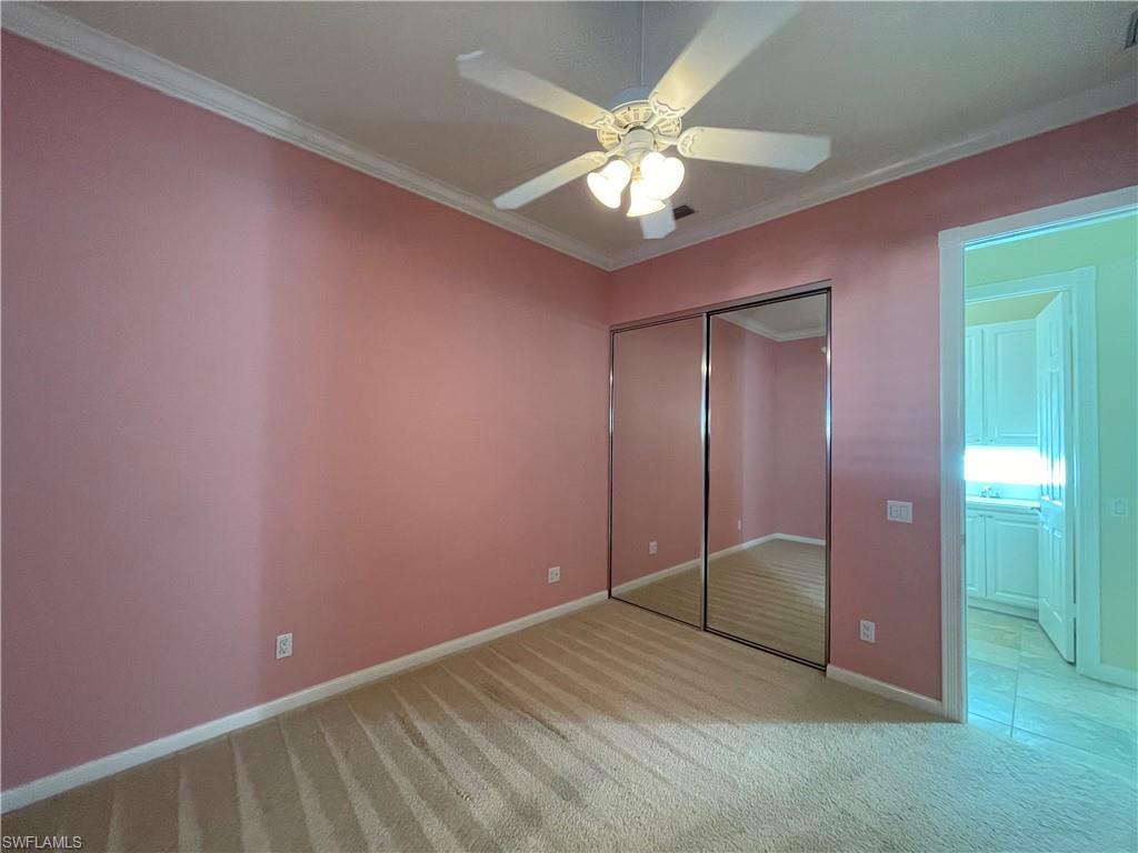 7025 Leopardi Court Naples, FL 34114 - Photo 26 of 48 a view of an empty room with a chandelier fan