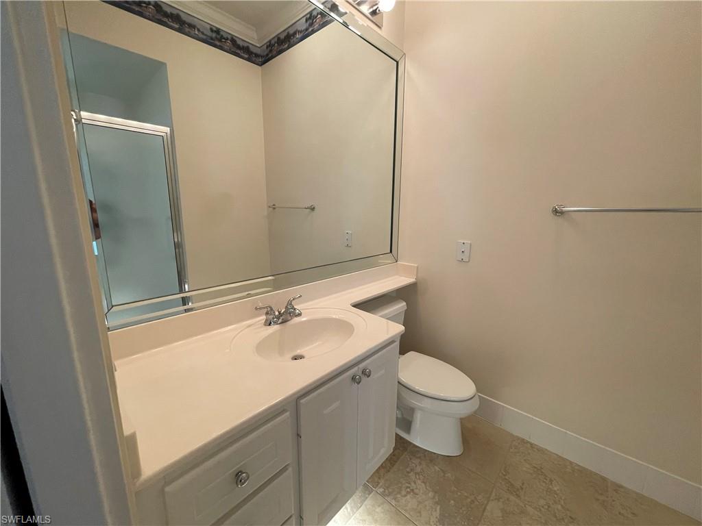 7025 Leopardi Court Naples, FL 34114 - Photo 28 of 48 a bathroom with a sink a toilet and a mirror