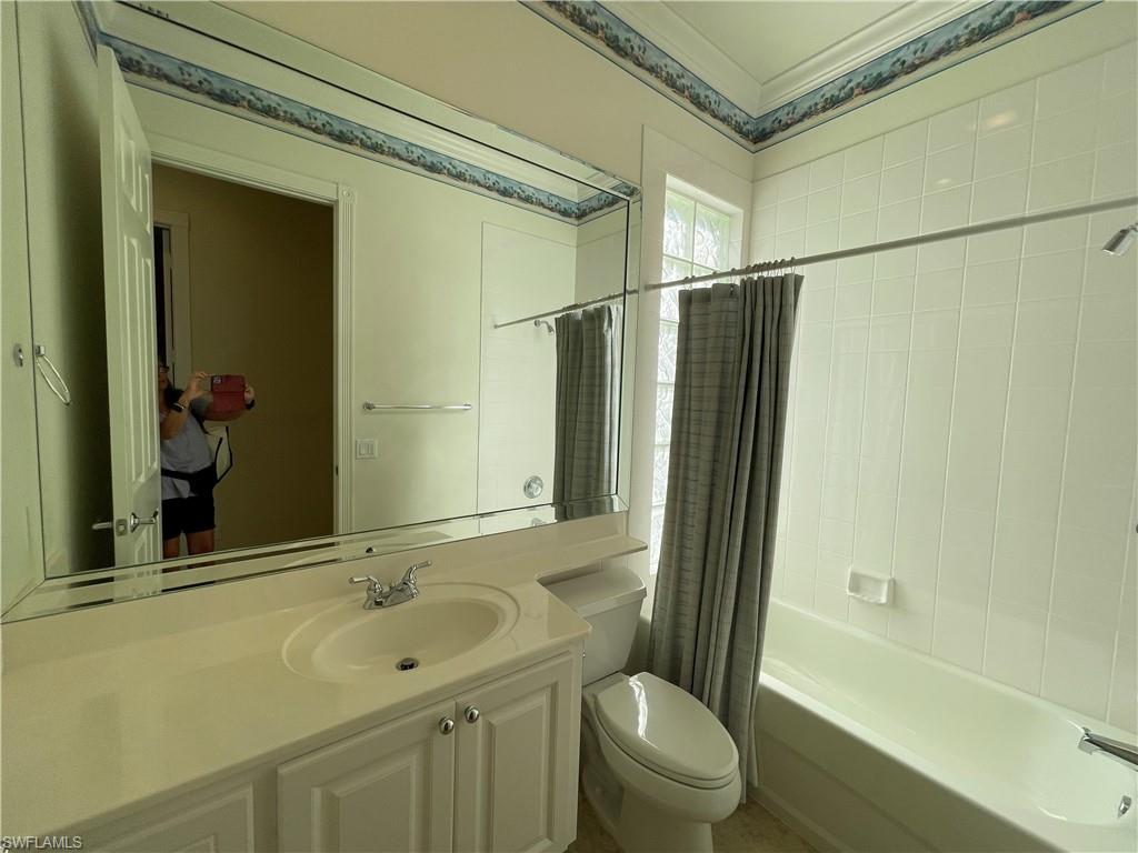 7025 Leopardi Court Naples, FL 34114 - Photo 29 of 48 a bathroom with a sink toilet and shower