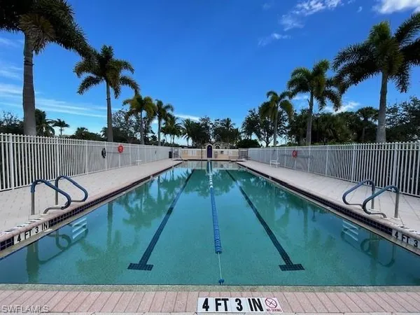 a view of swimming pool with outdoor seating and yard in back