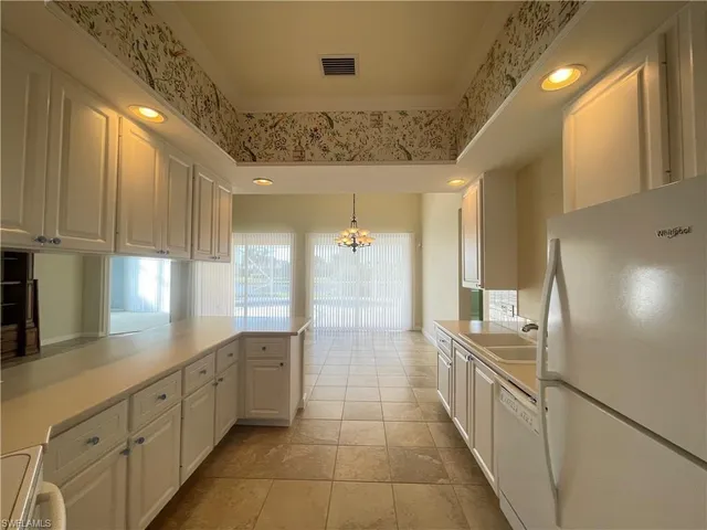 a kitchen with stainless steel appliances a refrigerator and cabinets