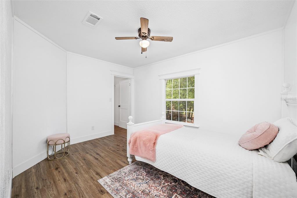 13076 Southwest 154th Street Archer, FL 32618 - Photo 33 of 60 a bedroom with a bed and wooden floor