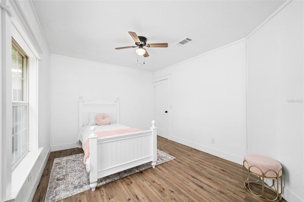 13076 Southwest 154th Street Archer, FL 32618 - Photo 35 of 60 a view of a room with wooden floor and ceiling fan