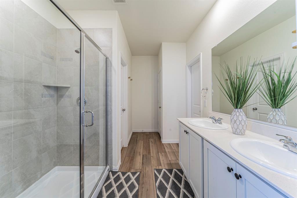 1240 Almond Road Azle, TX 76020 - Photo 12 of 26 a bathroom with a sink a mirror and a shower