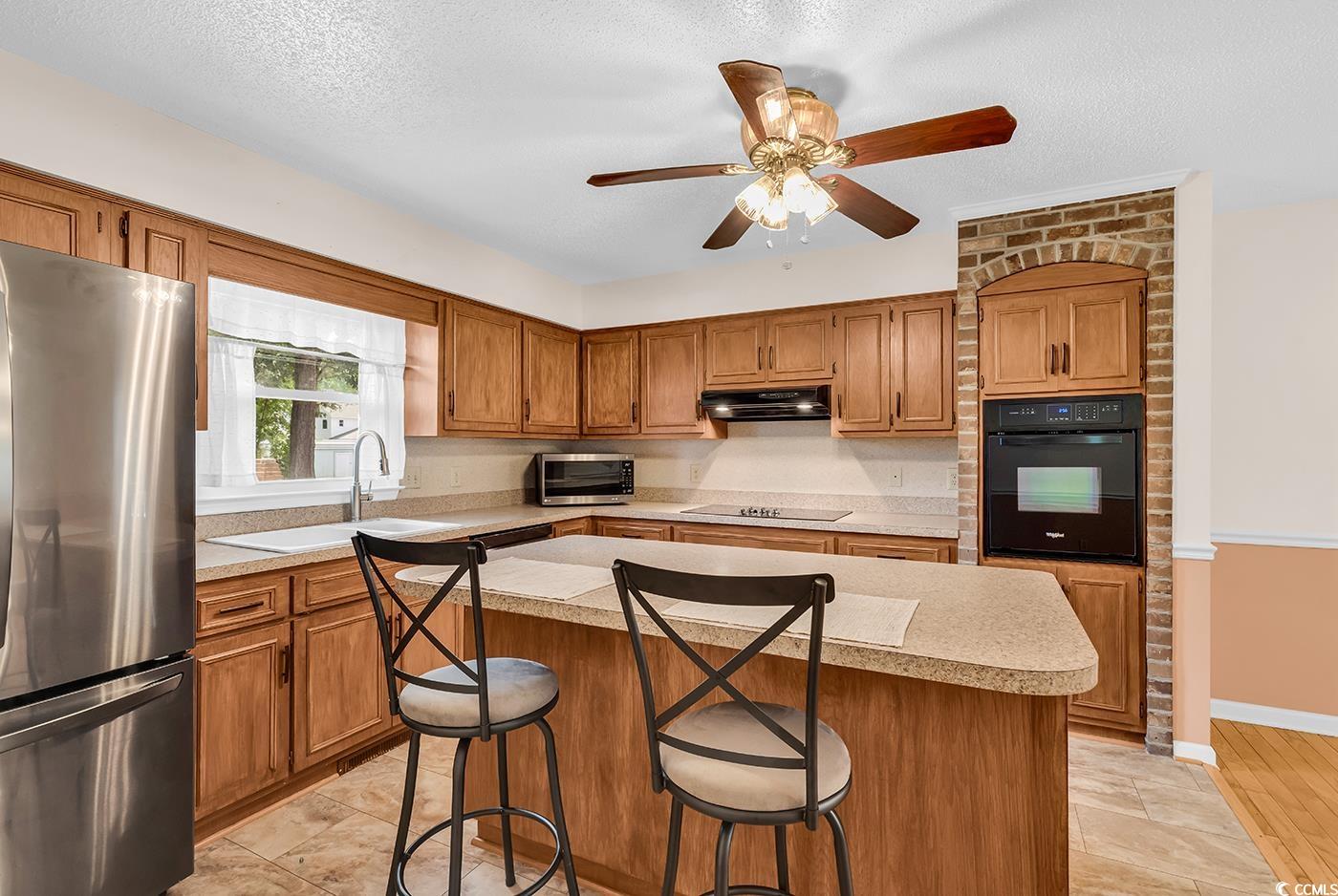 317 14th Avenue North Surfside Beach, SC 29575 - Photo 11 of 40 Kitchen with black appliances, light countertops,