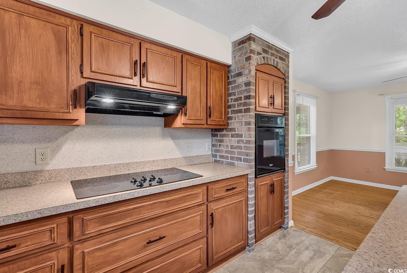 317 14th Avenue North Surfside Beach, SC 29575 - Photo 12 of 40 Kitchen with black appliances, under cabinet range
