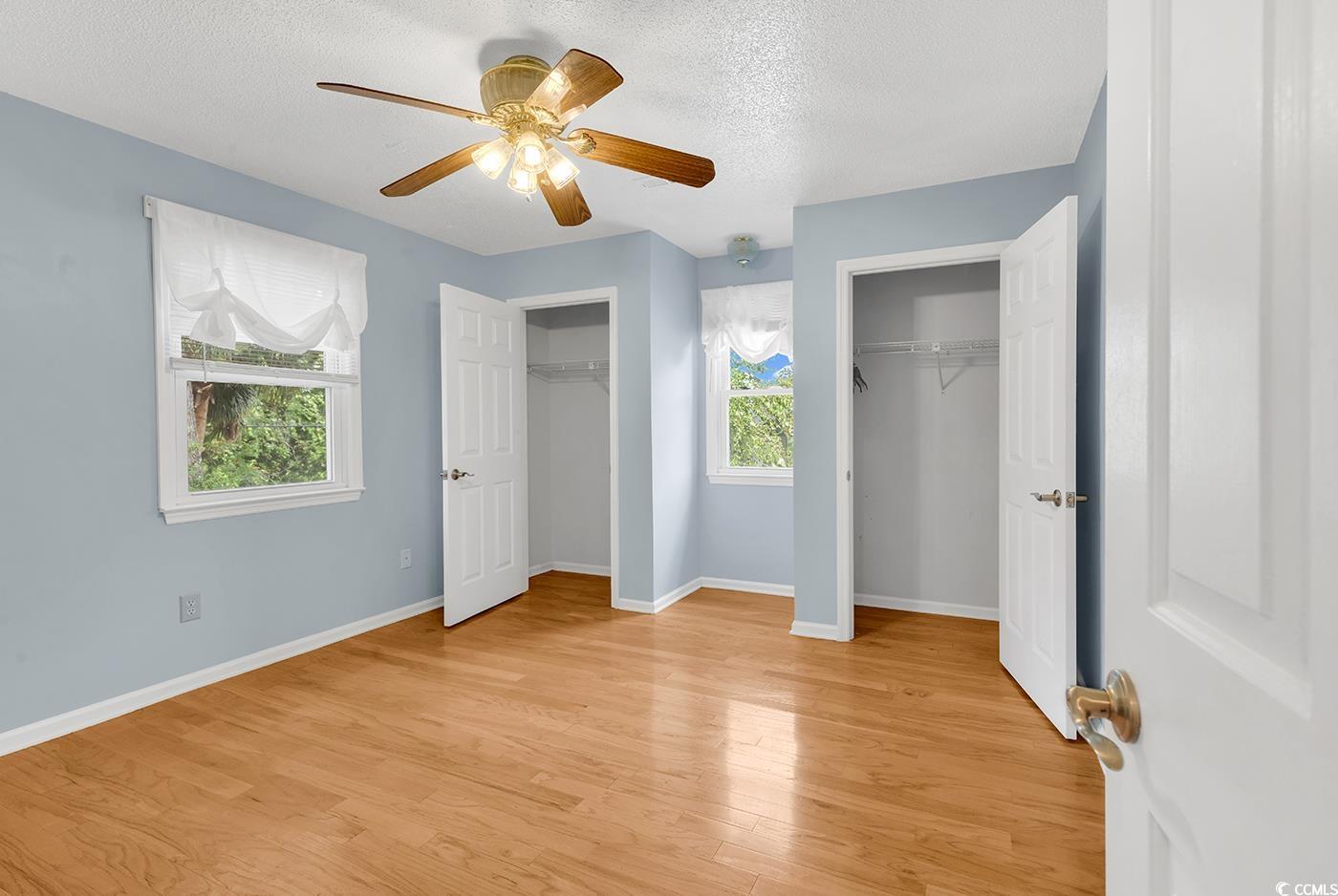 317 14th Avenue North Surfside Beach, SC 29575 - Photo 17 of 40 Unfurnished bedroom with two closets, light wood-s