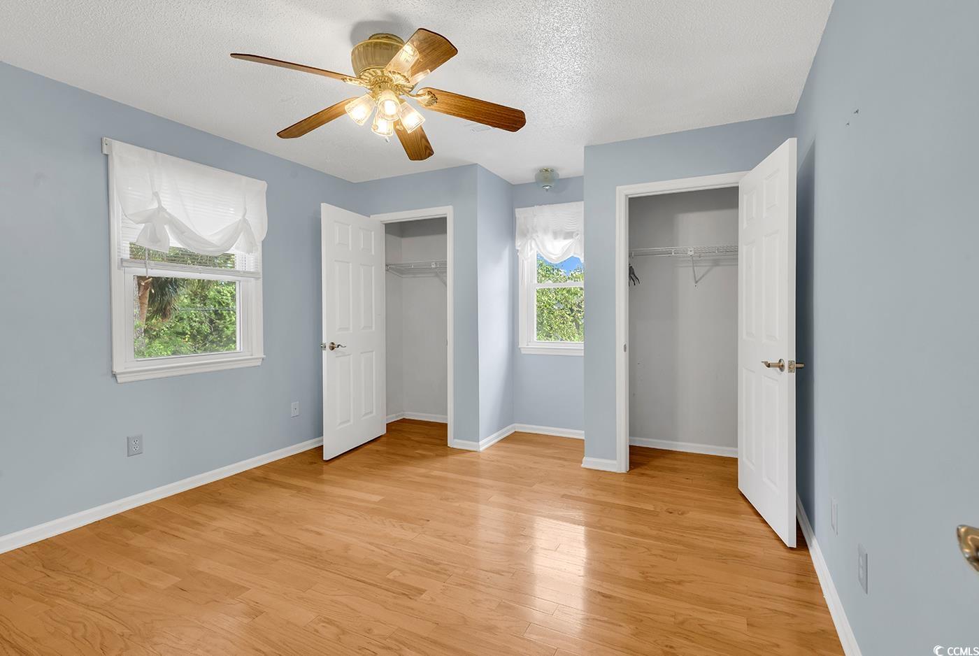 317 14th Avenue North Surfside Beach, SC 29575 - Photo 18 of 40 Unfurnished bedroom with multiple closets, light w
