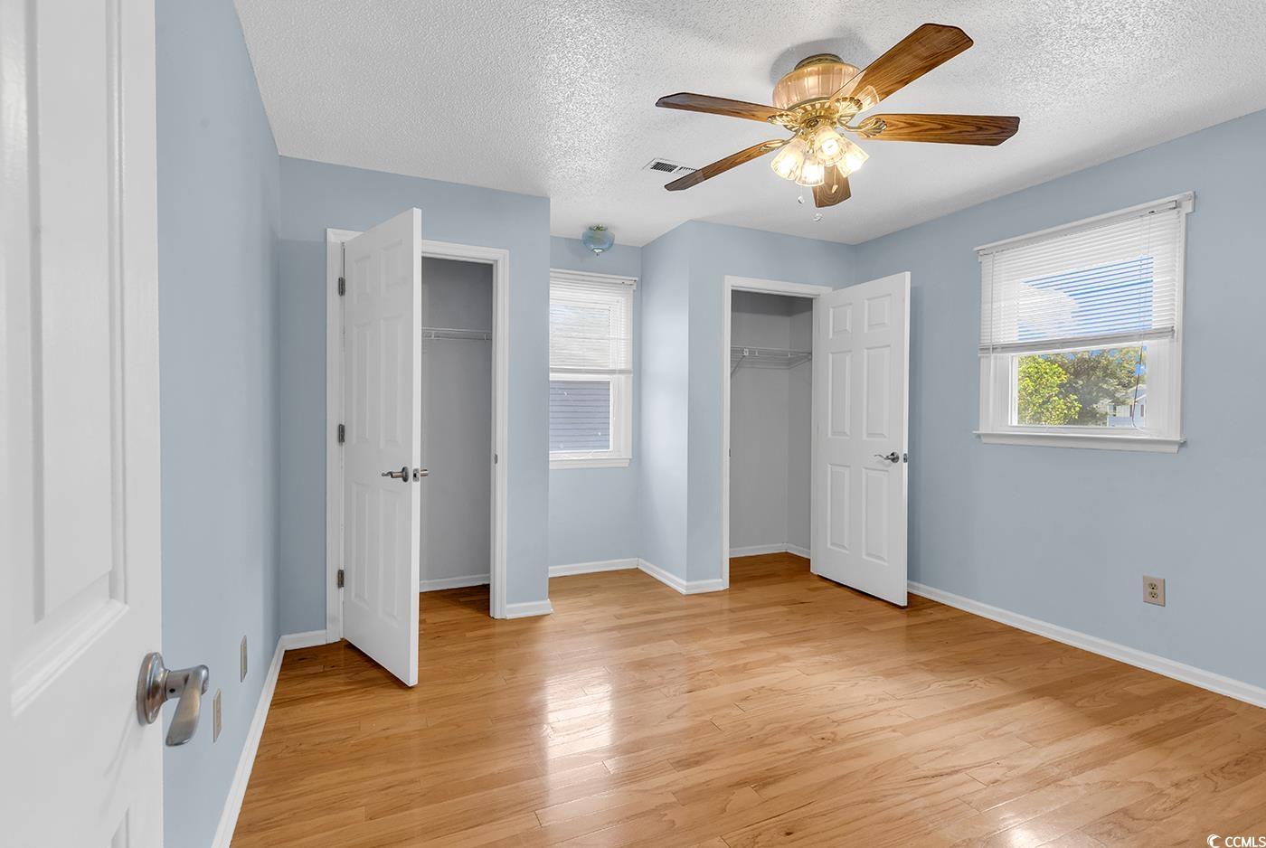 317 14th Avenue North Surfside Beach, SC 29575 - Photo 19 of 40 Unfurnished bedroom featuring multiple closets, a