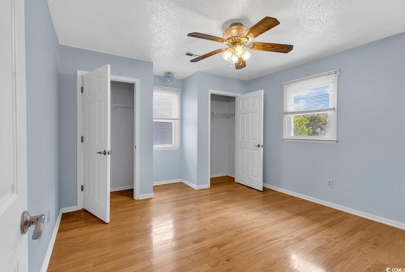 317 14th Avenue North Surfside Beach, SC 29575 - Photo 20 of 40 Unfurnished bedroom with multiple closets, light w
