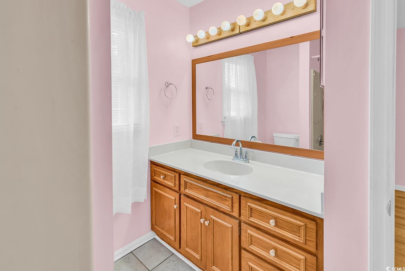 317 14th Avenue North Surfside Beach, SC 29575 - Photo 26 of 40 Bathroom with vanity and tile patterned flooring