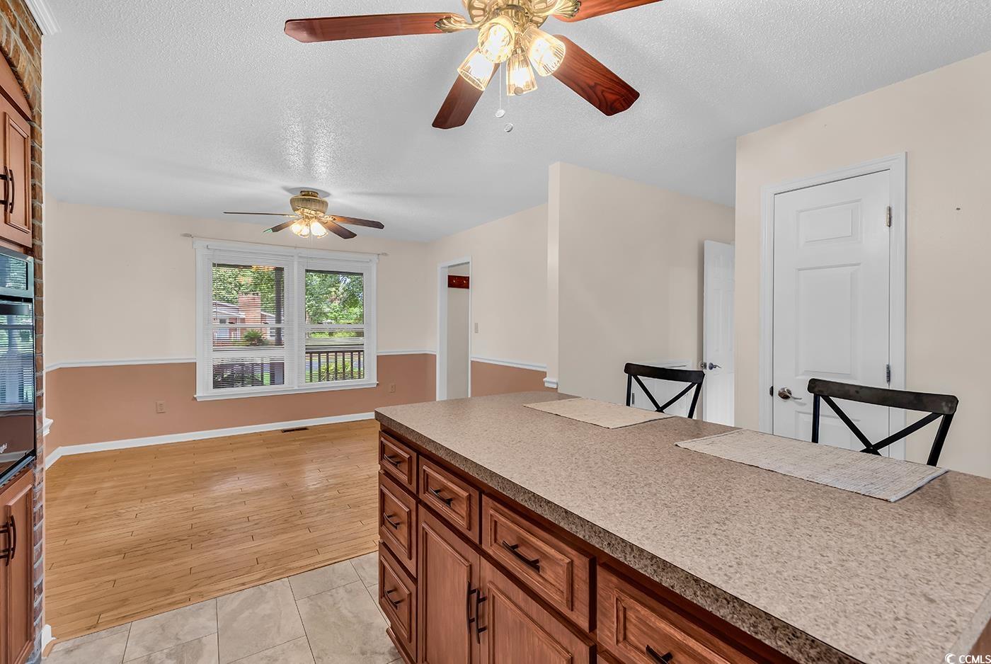 317 14th Avenue North Surfside Beach, SC 29575 - Photo 27 of 40 Kitchen with ceiling fan, a textured ceiling, brow