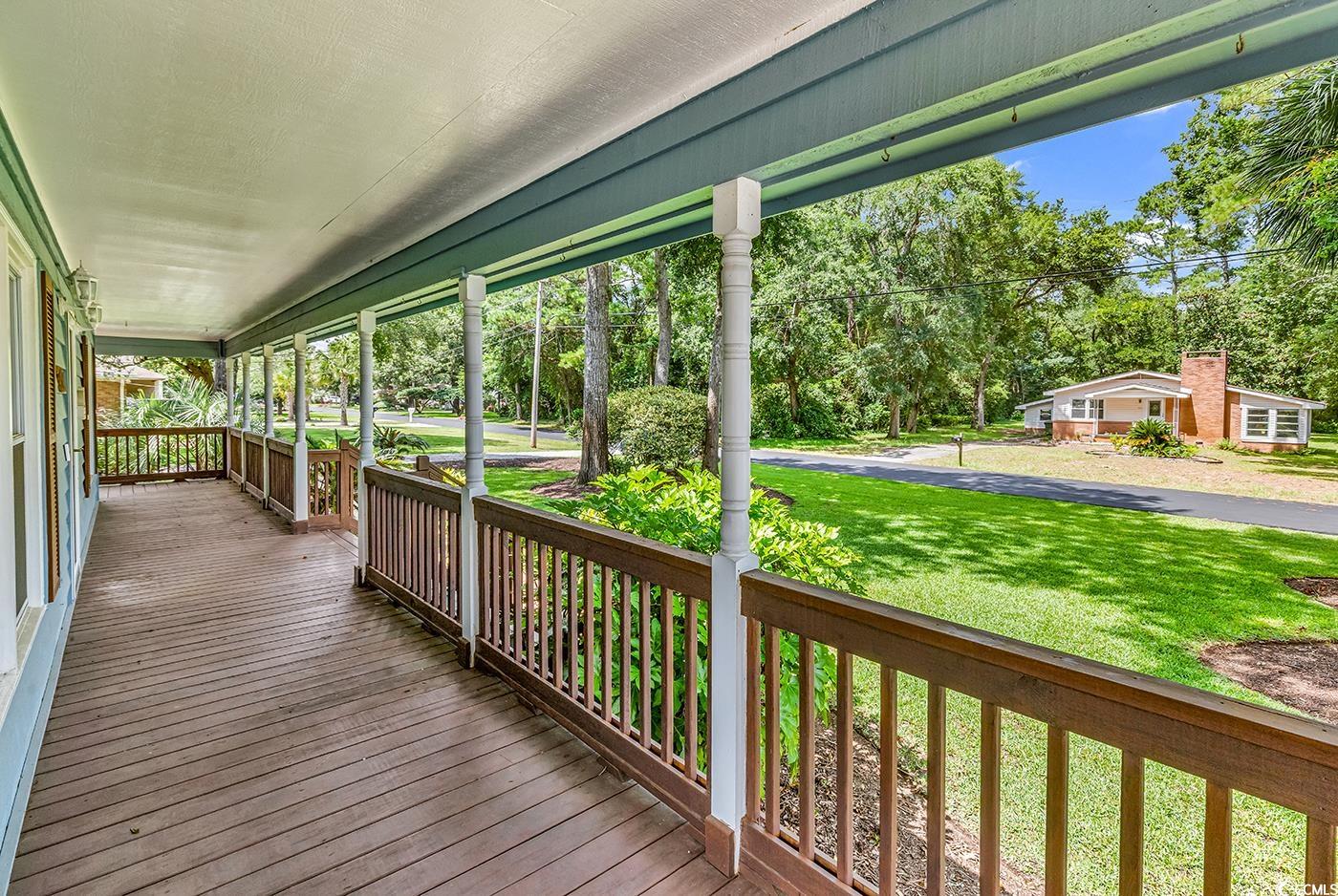 317 14th Avenue North Surfside Beach, SC 29575 - Photo 3 of 40 Wooden porch featuring a yard and view of wooded a