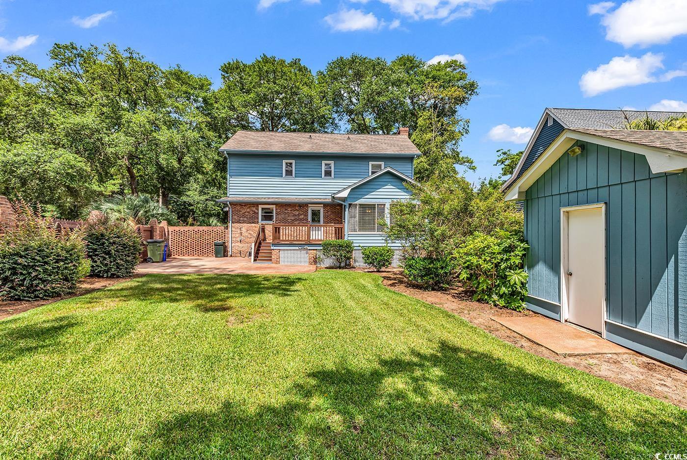 317 14th Avenue North Surfside Beach, SC 29575 - Photo 32 of 40 Rear view of house featuring a chimney, a yard, br