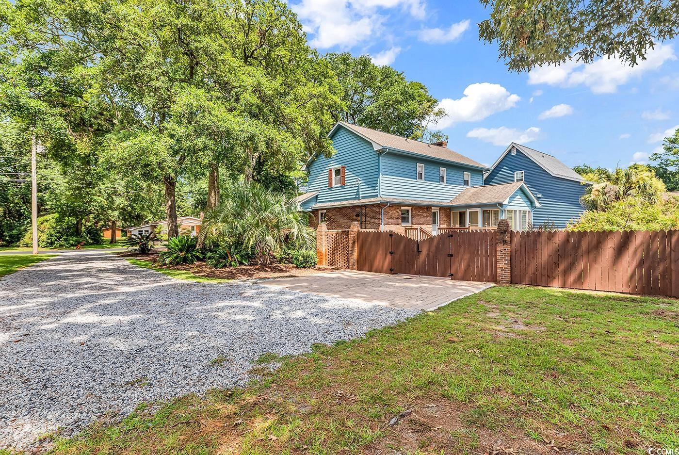 317 14th Avenue North Surfside Beach, SC 29575 - Photo 34 of 40 Rear view of house with a gate, driveway, and bric